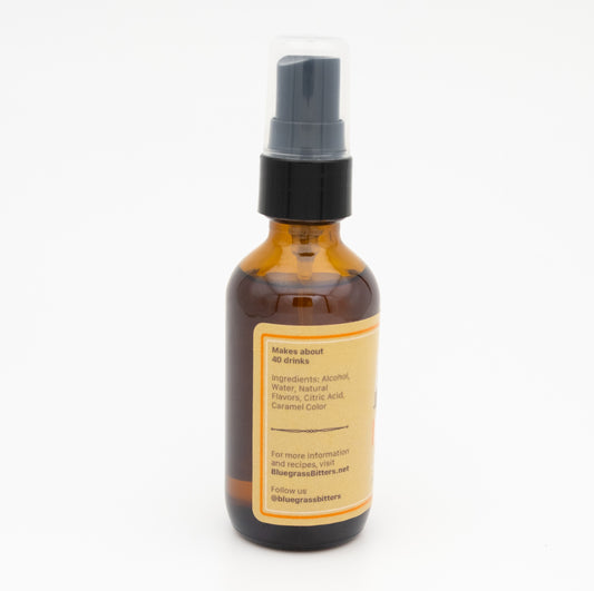 Amber glass bottle with a black spray nozzle on a white background